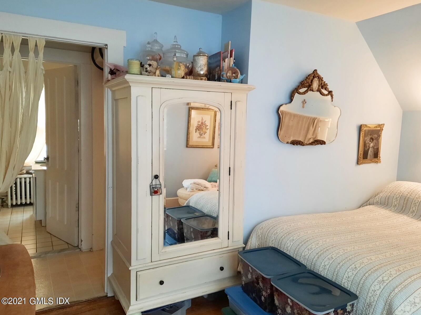 25 Orchard Street Cos Cob, CT 06807 - Photo 4 of 6 a bedroom with a bed and a mirror