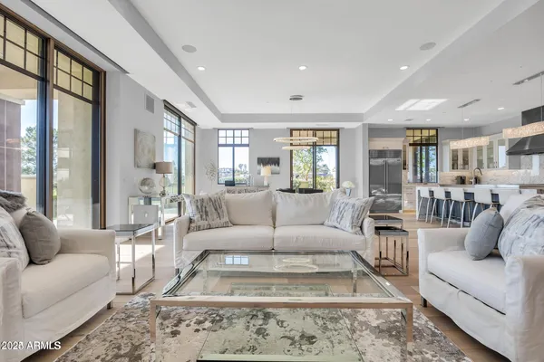 a living room with furniture wooden floor and a large window