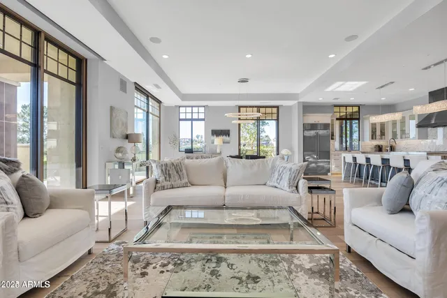 a living room with furniture wooden floor and a large window