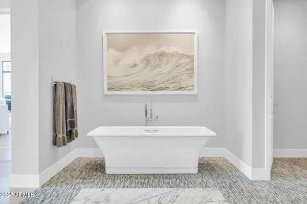 a white bath tub sitting next to a white sink