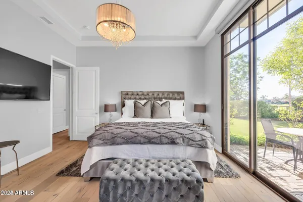 a bedroom with a bed and wooden floor