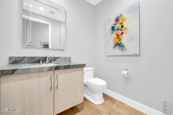 a bathroom with a granite countertop sink and a mirror