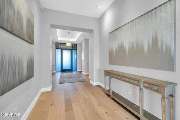 a view of a hallway with wooden floor and staircase