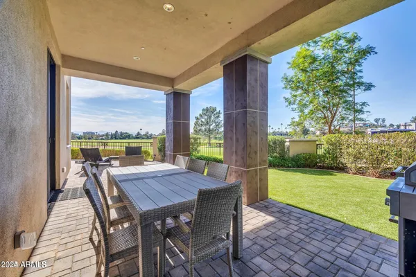 a view of a patio with a table chairs and a backyard