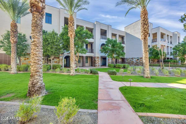 a view of a big yard in front of a brick house with a large windows