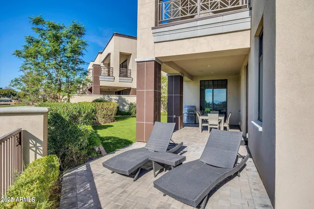a view of a patio with couches table and chairs and potted plants