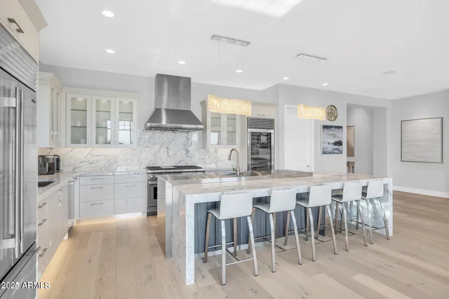 a kitchen with cabinets and chairs