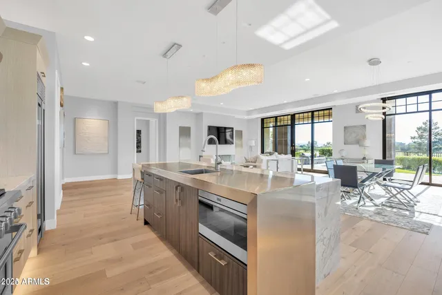 a large kitchen with stainless steel appliances granite countertop a large counter top and sink