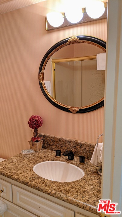 880 West 1st Street, Unit 603 Los Angeles, CA 90012 - Photo 16 of 54 a bathroom with a sink and mirror