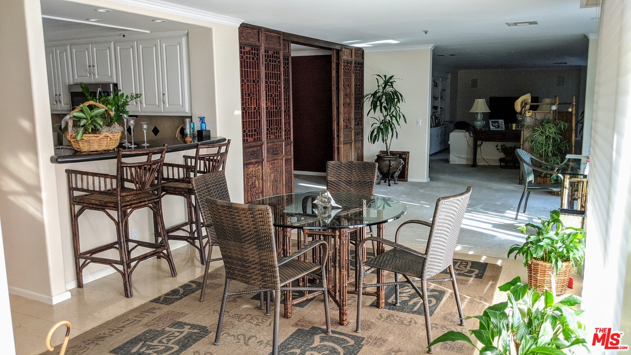 880 West 1st Street, Unit 603 Los Angeles, CA 90012 - Photo 23 of 54 a view of a dining room with furniture one side kitchen view