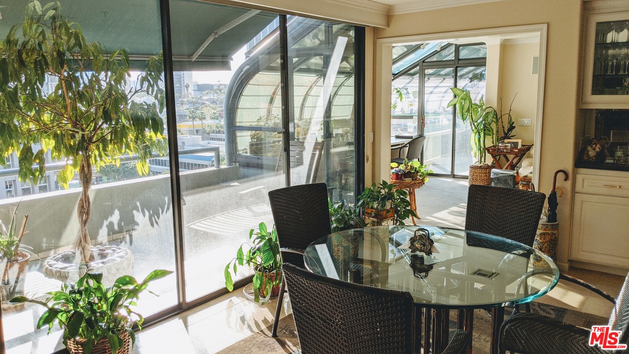 880 West 1st Street, Unit 603 Los Angeles, CA 90012 - Photo 26 of 54 a view of a dining room with furniture large windows and wooden floor