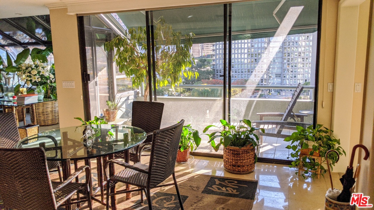 880 West 1st Street, Unit 603 Los Angeles, CA 90012 - Photo 27 of 54 a dining room with furniture potted plants and wooden floor