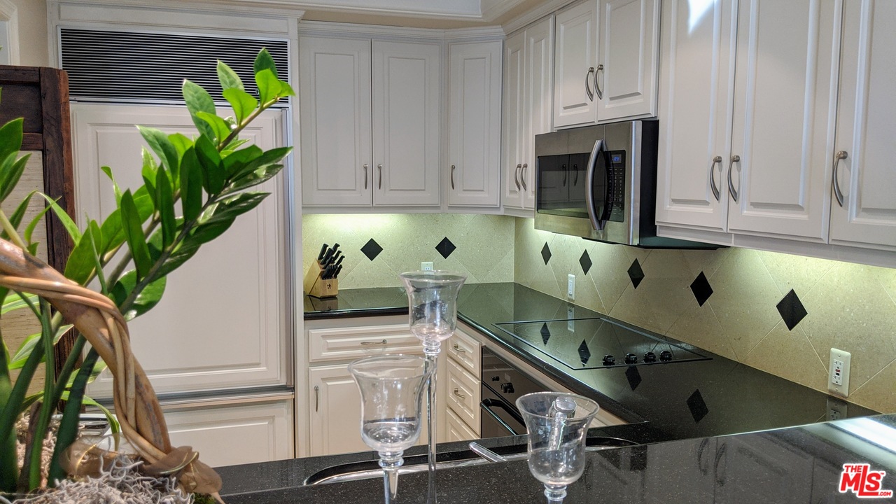 880 West 1st Street, Unit 603 Los Angeles, CA 90012 - Photo 33 of 54 a kitchen with appliances cabinets and a potted plant
