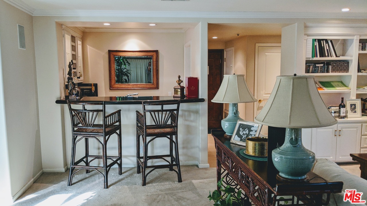 880 West 1st Street, Unit 603 Los Angeles, CA 90012 - Photo 39 of 54 a room with a table chairs and a kitchen view