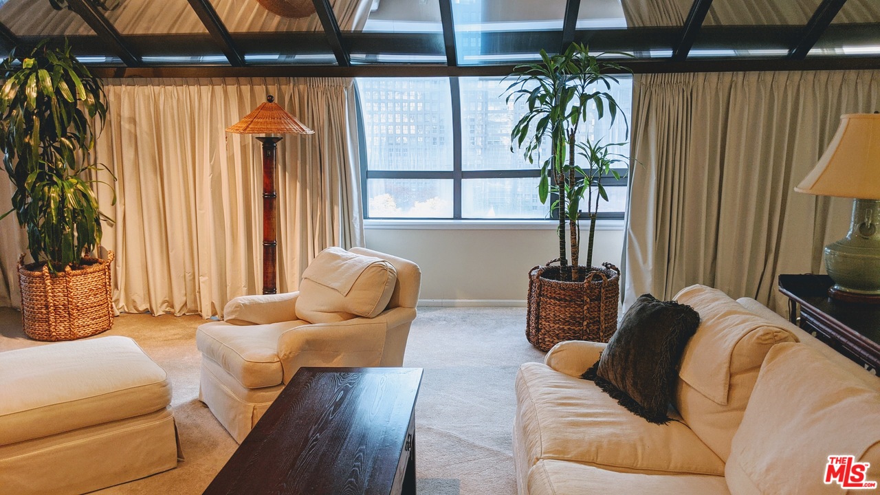 880 West 1st Street, Unit 603 Los Angeles, CA 90012 - Photo 41 of 54 a living room with furniture and a large window