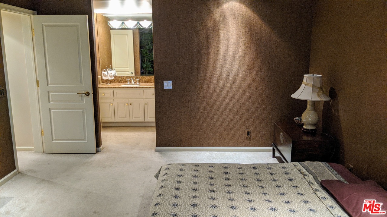 880 West 1st Street, Unit 603 Los Angeles, CA 90012 - Photo 47 of 54 a bedroom with a bed and a table in it