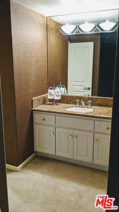 880 West 1st Street, Unit 603 Los Angeles, CA 90012 - Photo 52 of 54 a bathroom with a sink and a mirror