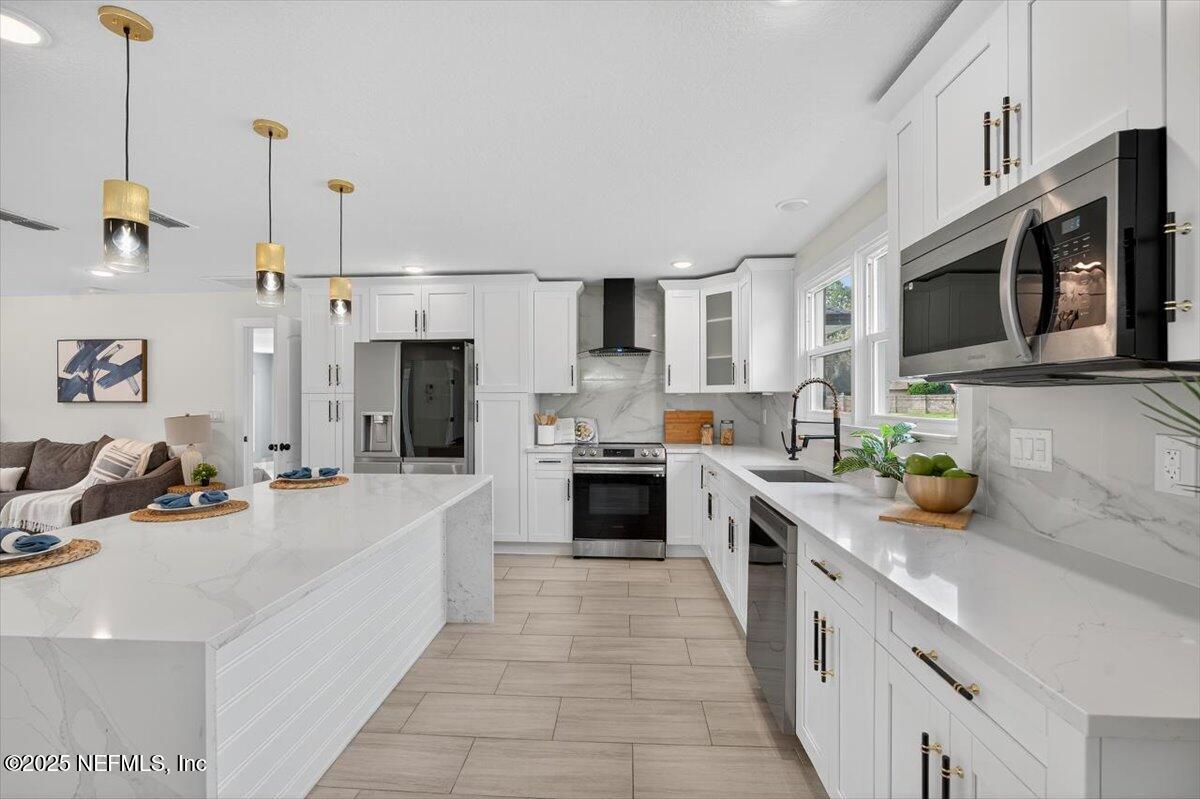 10779 Scott Mill Road Jacksonville, FL 32223 - Photo 12 of 82 a large kitchen with a stove top oven a sink a counter space and cabinets