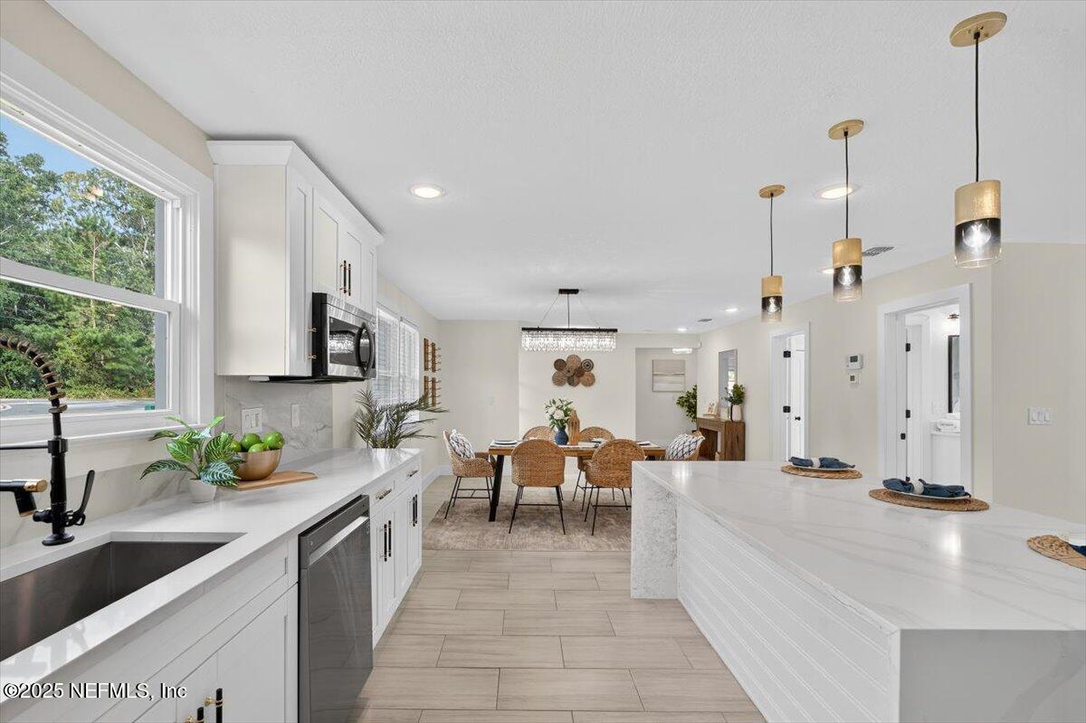 10779 Scott Mill Road Jacksonville, FL 32223 - Photo 14 of 82 a large kitchen with lots of counter space and windows