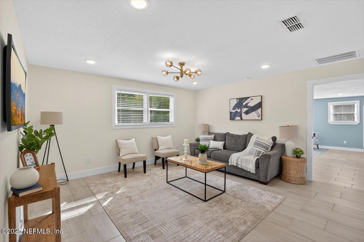 10779 Scott Mill Road Jacksonville, FL 32223 - Photo 17 of 82 a living room with furniture and a potted plant