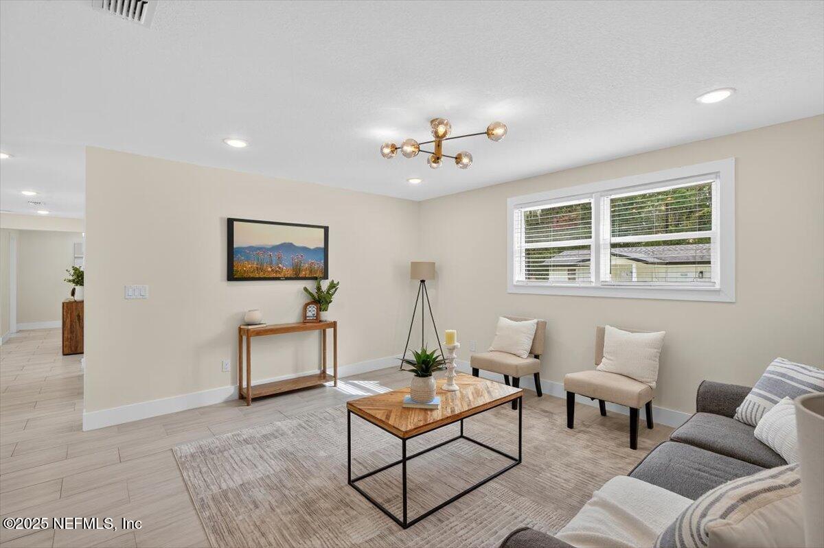 10779 Scott Mill Road Jacksonville, FL 32223 - Photo 18 of 82 a living room with furniture a table and a window