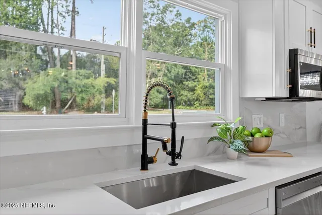 a bedroom with furniture and a large window