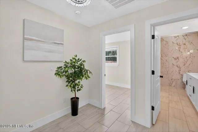 a bedroom with a bed and glass windows