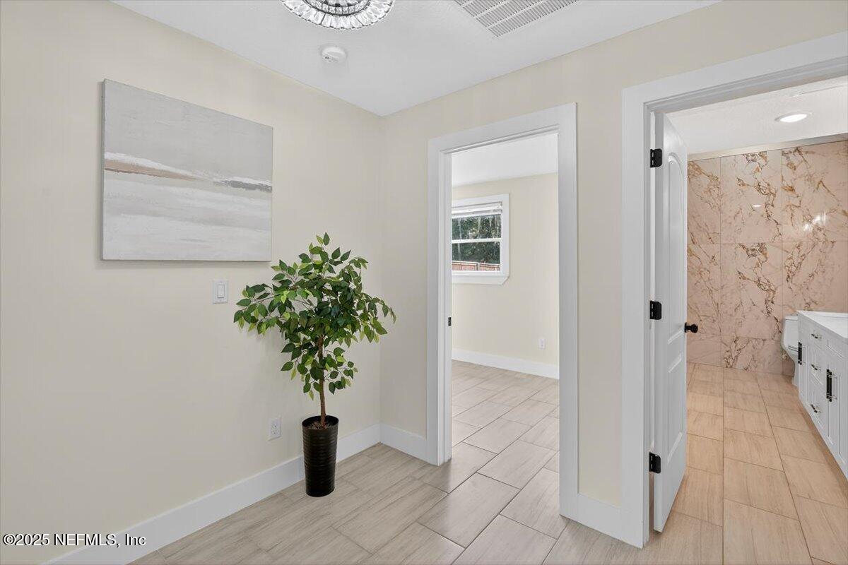 10779 Scott Mill Road Jacksonville, FL 32223 - Photo 22 of 82 a plant sitting in a bathroom next to a window