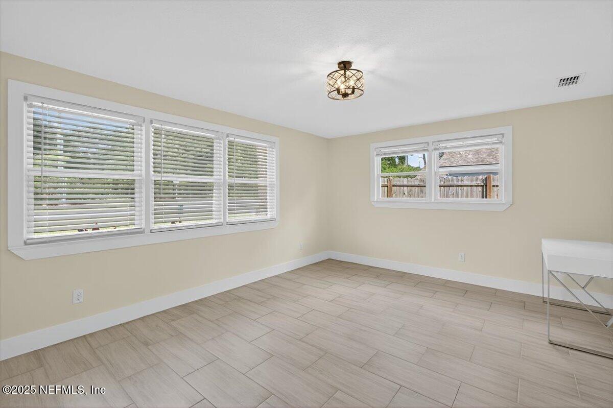 10779 Scott Mill Road Jacksonville, FL 32223 - Photo 23 of 82 a view of an empty room with a window