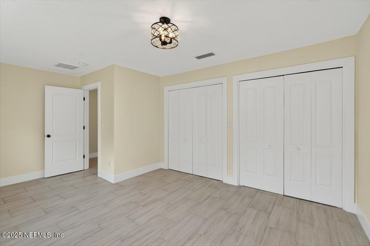 10779 Scott Mill Road Jacksonville, FL 32223 - Photo 26 of 82 a view of an empty room with wooden floor