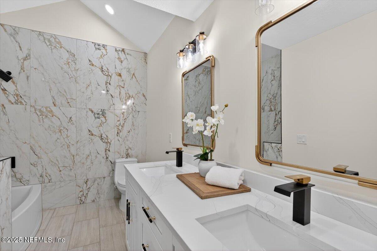 10779 Scott Mill Road Jacksonville, FL 32223 - Photo 27 of 82 a bathroom with a sink and a mirror