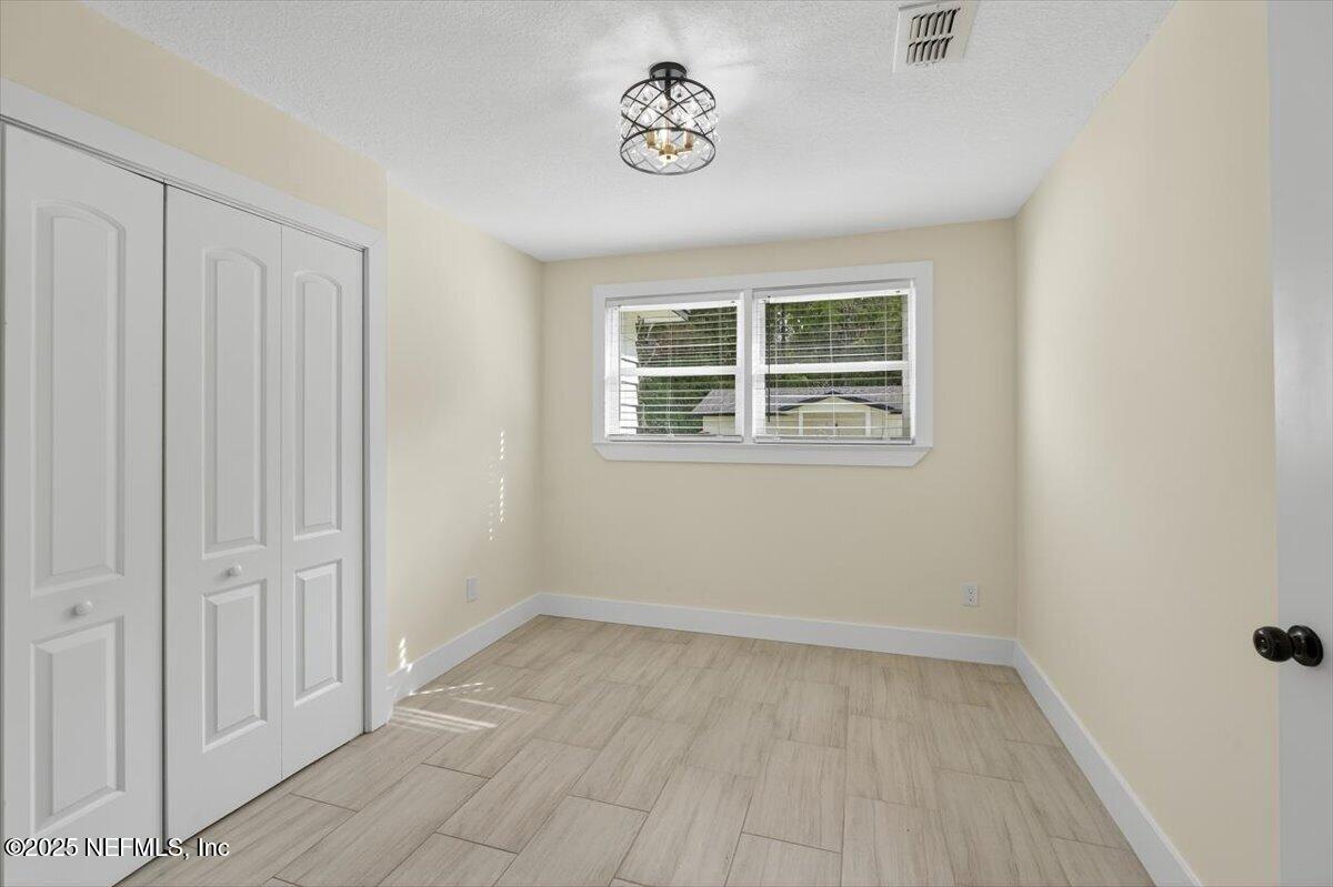 10779 Scott Mill Road Jacksonville, FL 32223 - Photo 30 of 82 an empty room with a window