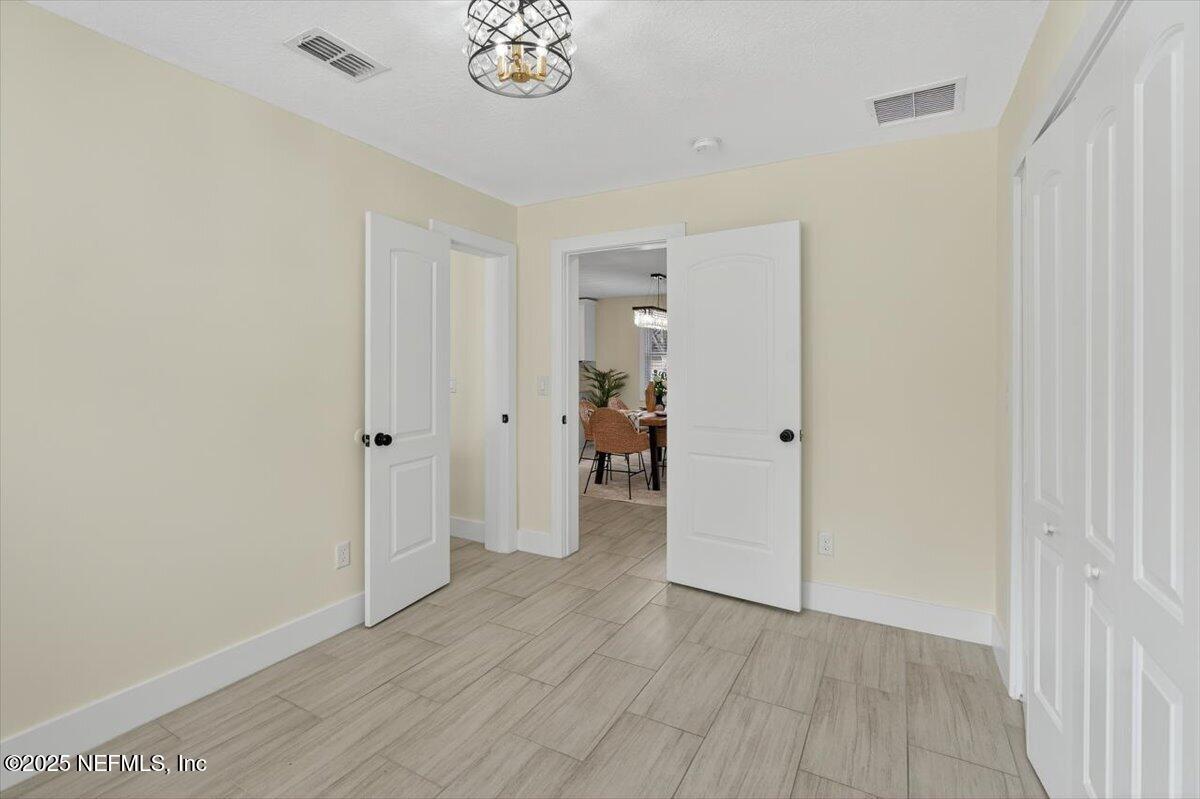 10779 Scott Mill Road Jacksonville, FL 32223 - Photo 31 of 82 a view of an empty room with wooden floor