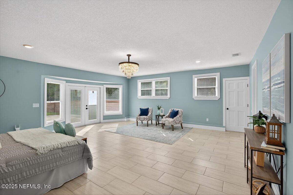 10779 Scott Mill Road Jacksonville, FL 32223 - Photo 35 of 82 a bedroom with furniture and a large window