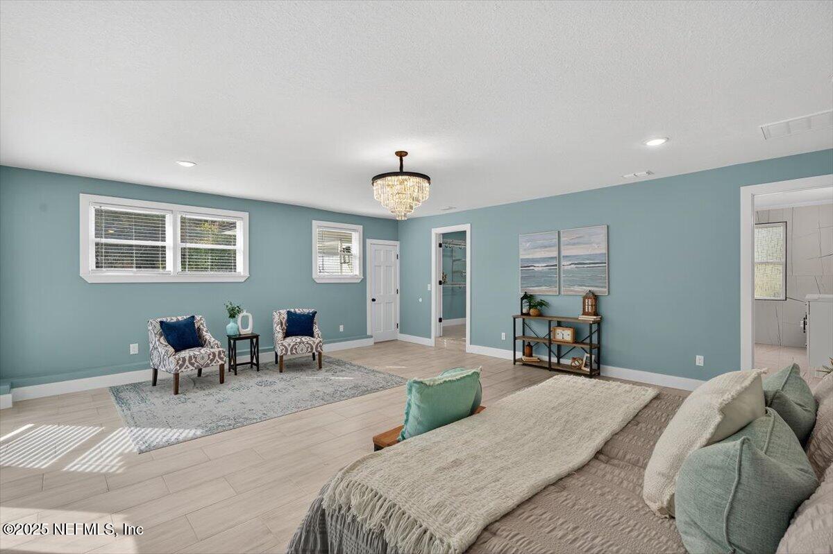 10779 Scott Mill Road Jacksonville, FL 32223 - Photo 38 of 82 a bedroom with a bed and glass windows