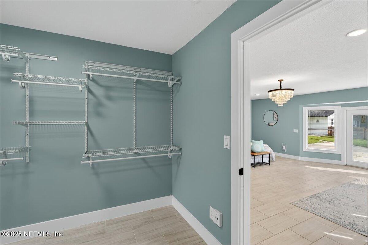 10779 Scott Mill Road Jacksonville, FL 32223 - Photo 40 of 82 a view of a room with wooden floor and a ceiling fan