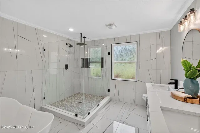 an aerial view of a house with a swimming pool a yard and a garage