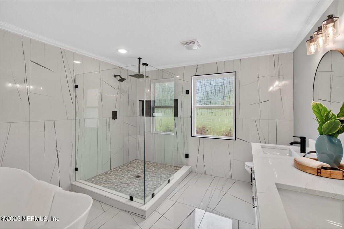 10779 Scott Mill Road Jacksonville, FL 32223 - Photo 41 of 82 a bathroom with a shower sink and mirror