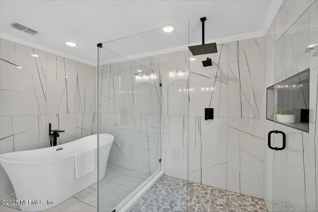 an aerial view of a house with swimming pool and large trees