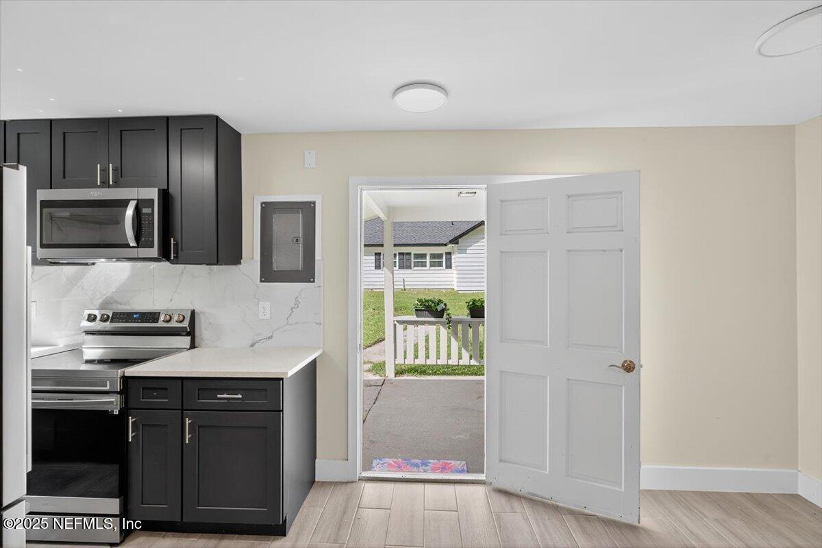 10779 Scott Mill Road Jacksonville, FL 32223 - Photo 46 of 82 a kitchen with stainless steel appliances granite countertop a stove a sink and a refrigerator