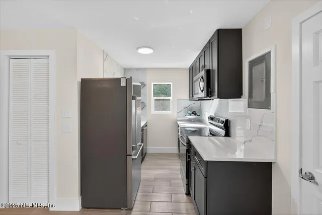 a front view of a house with yard and green space