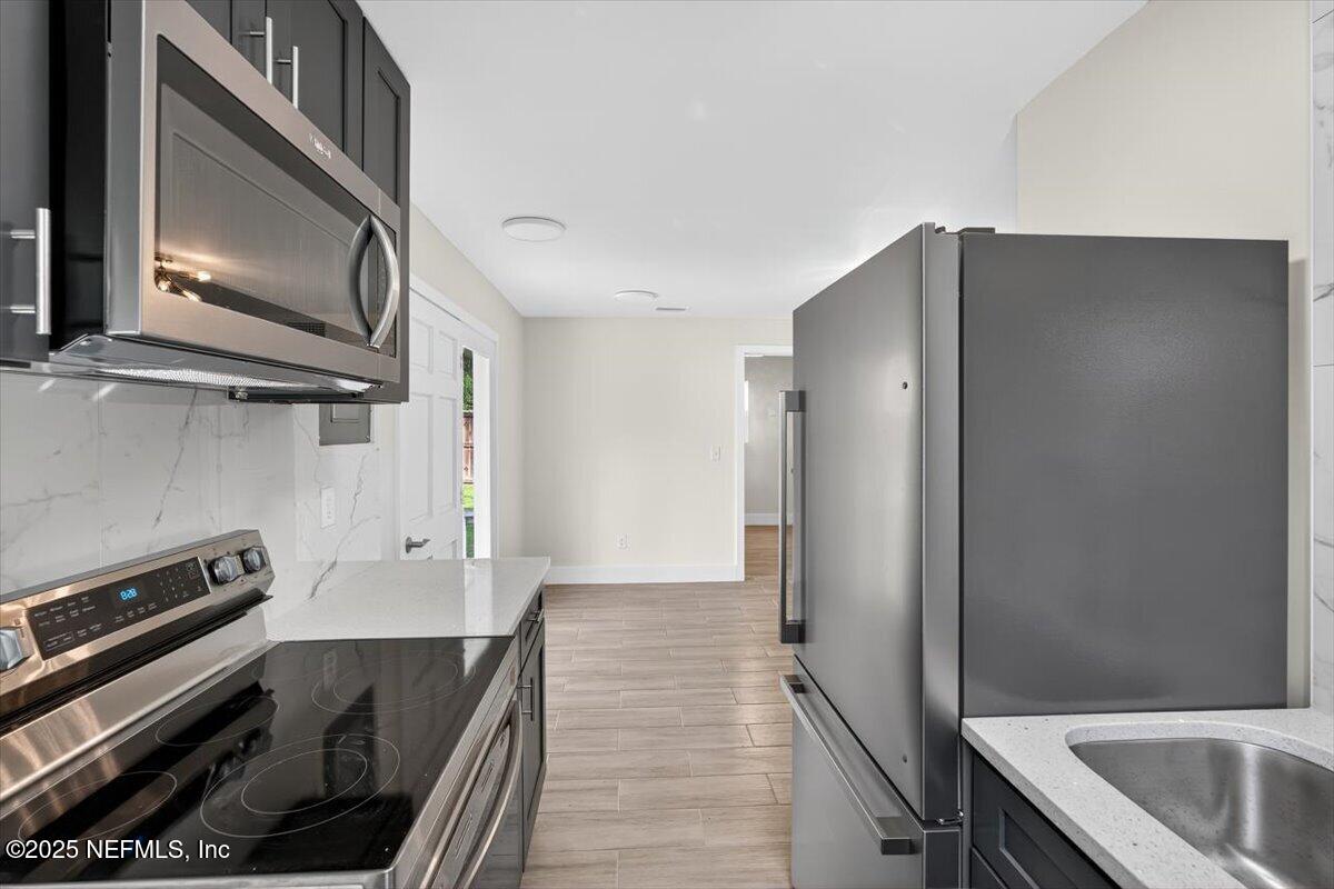 10779 Scott Mill Road Jacksonville, FL 32223 - Photo 51 of 82 a kitchen with a refrigerator stove and microwave
