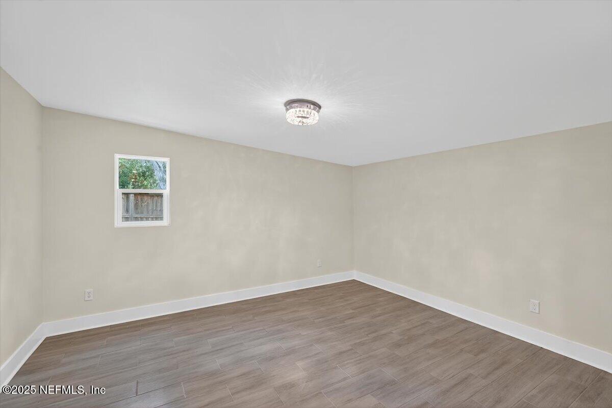 10779 Scott Mill Road Jacksonville, FL 32223 - Photo 54 of 82 a view of a room with wooden floor and window