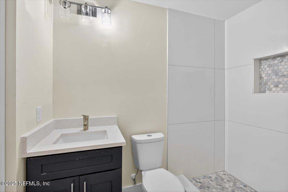 10779 Scott Mill Road Jacksonville, FL 32223 - Photo 57 of 82 a bathroom with a sink a toilet and a shower