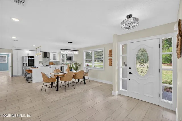 a large kitchen with a stove top oven a sink a counter space and cabinets