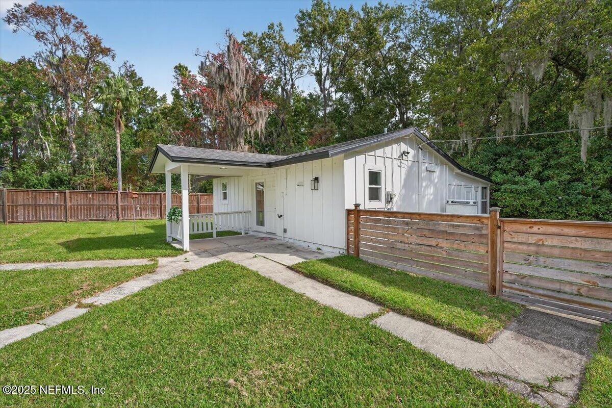 10779 Scott Mill Road Jacksonville, FL 32223 - Photo 61 of 82 a front view of a house with a yard