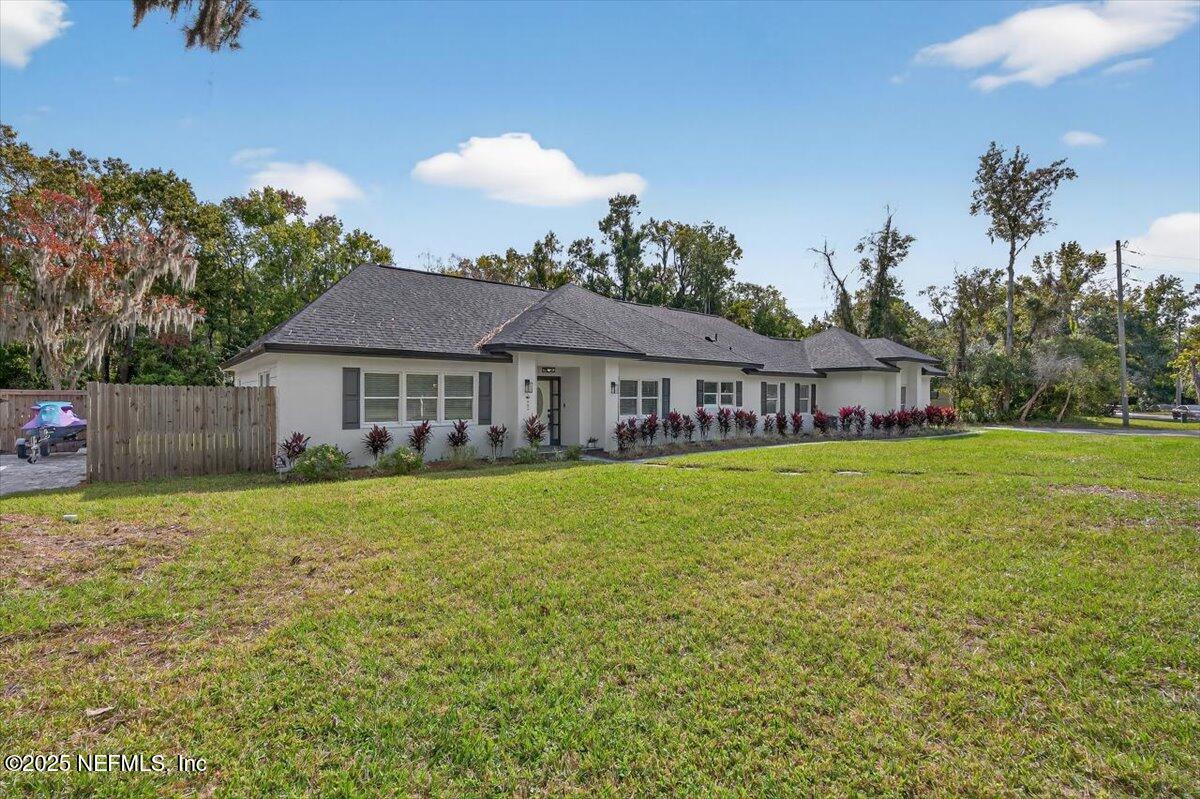10779 Scott Mill Road Jacksonville, FL 32223 - Photo 80 of 82 a front view of a house with yard and green space