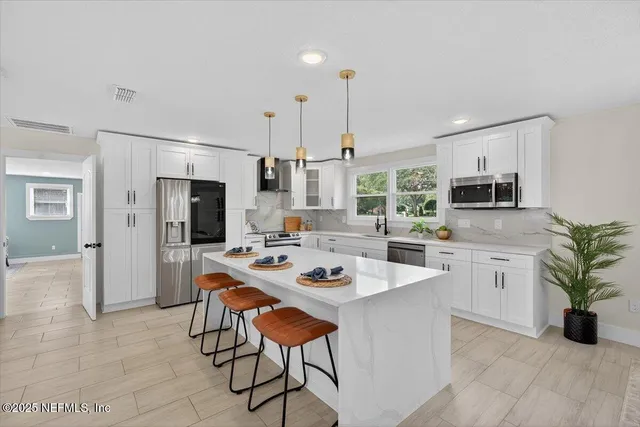 a living room with furniture a table and a window