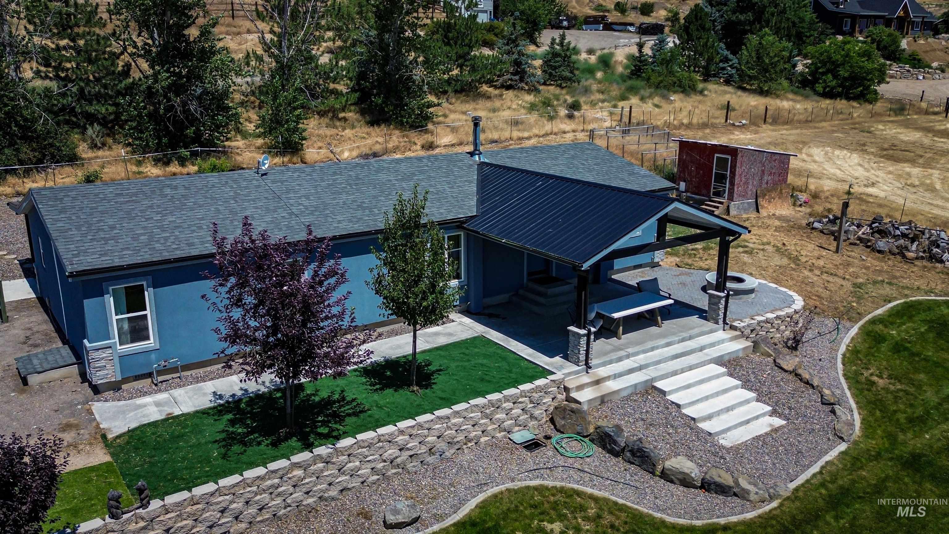 23904 Southview Lane Middleton, ID 83644 - Photo 19 of 29 Blue exterior with a dark shingled roof and stone accents