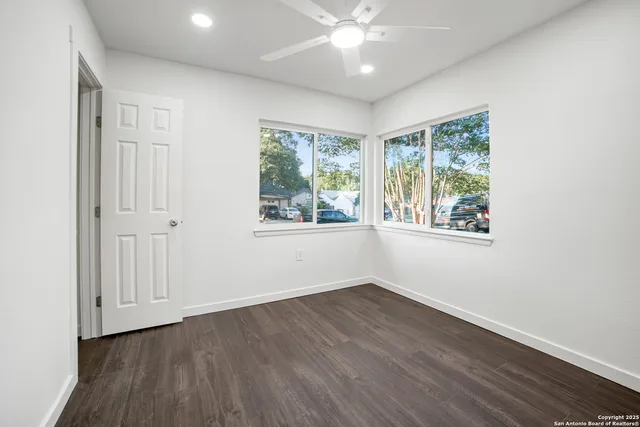 wooden floor in an empty room with a window